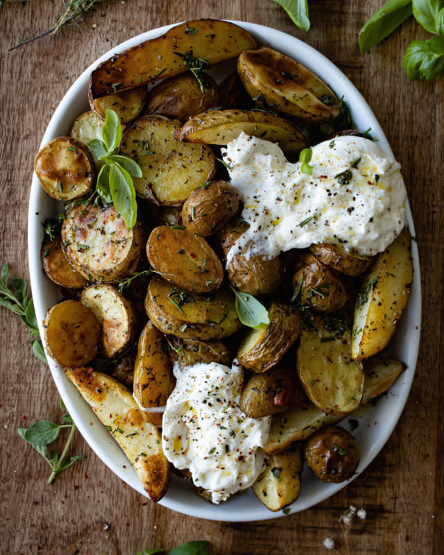 <p>Inspired with a Twist</p><p>Roasted tomatoes flavored with savory herbs and topped with creamy burrata.</p><p><strong>Get the recipe: <a href="https://www.inspiredwithatwist.com/home/roastedherbypotatoes" rel="nofollow noopener" target="_blank" data-ylk="slk:Roasted Herby Potatoes with Burrata;elm:context_link;itc:0;sec:content-canvas" class="link rapid-noclick-resp"><em>Roasted Herby Potatoes with Burrata</em></a></strong></p>