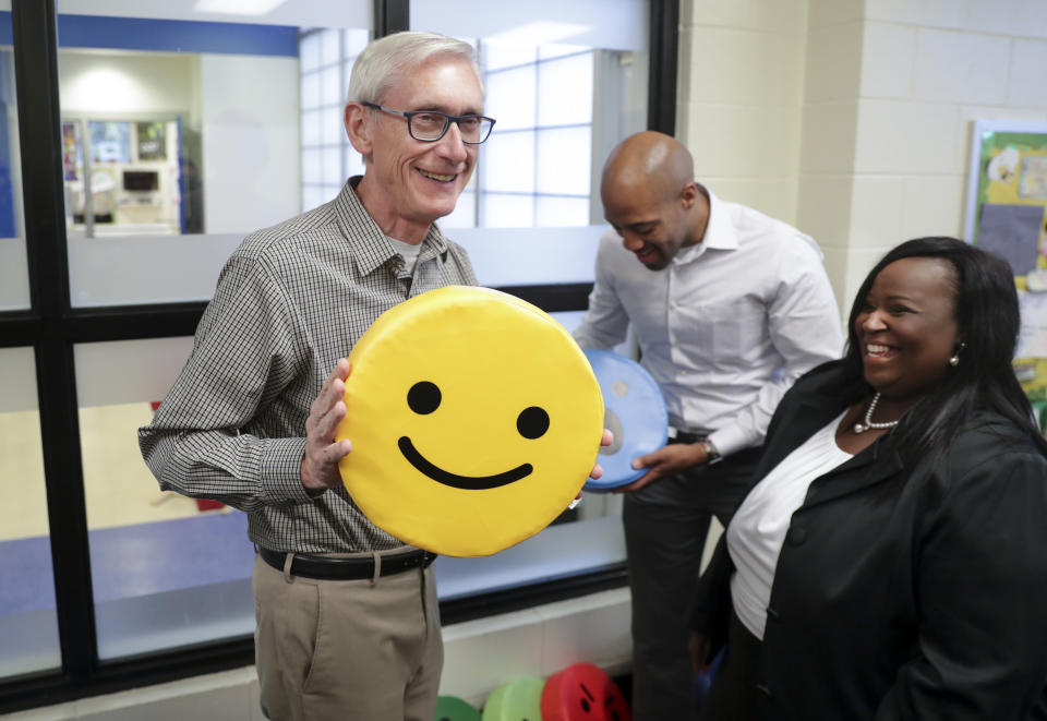 FILE - In this Nov. 7, 2018 file photo, Governor-elect Tony Evers, left, and Lt. Governor-elect Mandela Barnes, center, with pillows found on the tour of the Boys & Girls Club of Dane County. Gov. Evers made it official Saturday, June 5, 2021, announcing his bid for a second term in the battleground state where he stands as a Democratic block to the Republican-controlled state Legislature. (Steve Apps/Wisconsin State Journal via AP File)