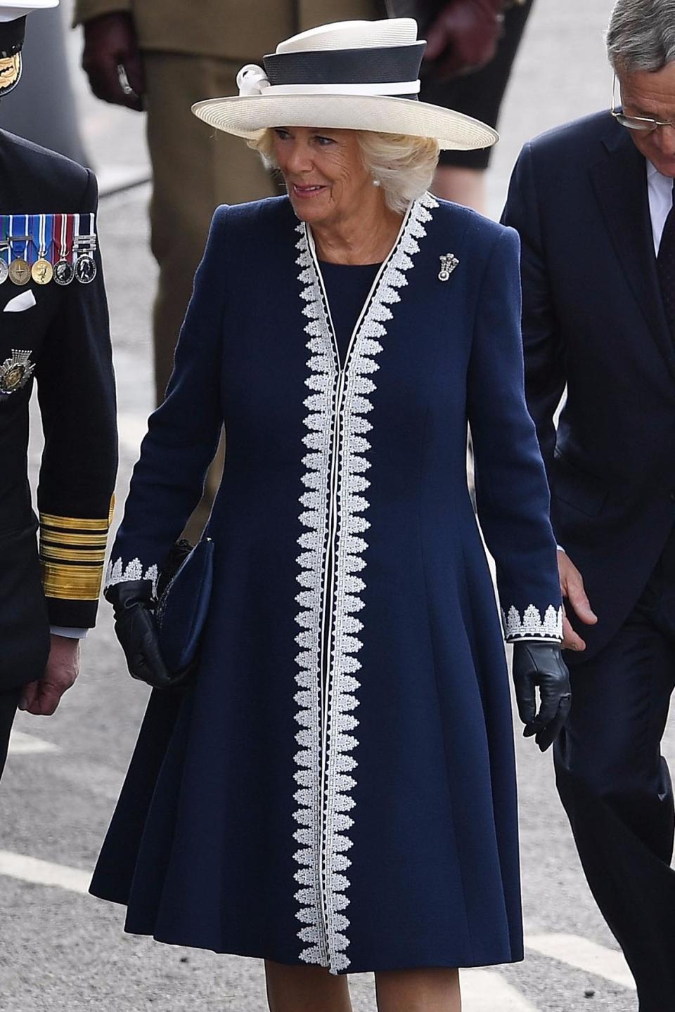 The design and matching hat game resembles this navy and white coat Camilla was seen in earlier this month.