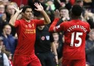 Liverpool's Luis Suarez (L) celebrates with teammate Daniel Sturridge after scoring a goal against Fulham during their English Premier League soccer match at Anfield in Liverpool, northern England November 9, 2013.