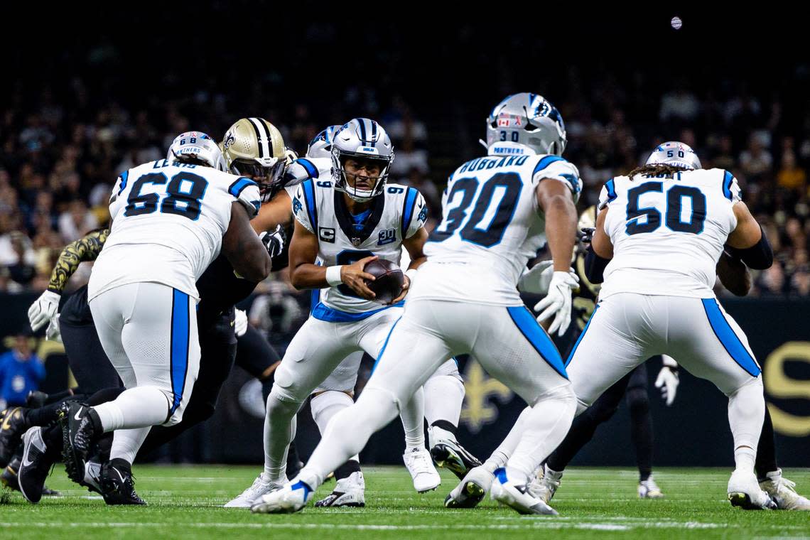 Carolina Panthers quarterback Bryce Young (9) hands off to running back Chuba Hubbard (30) during the first half at Caesars Superdome.