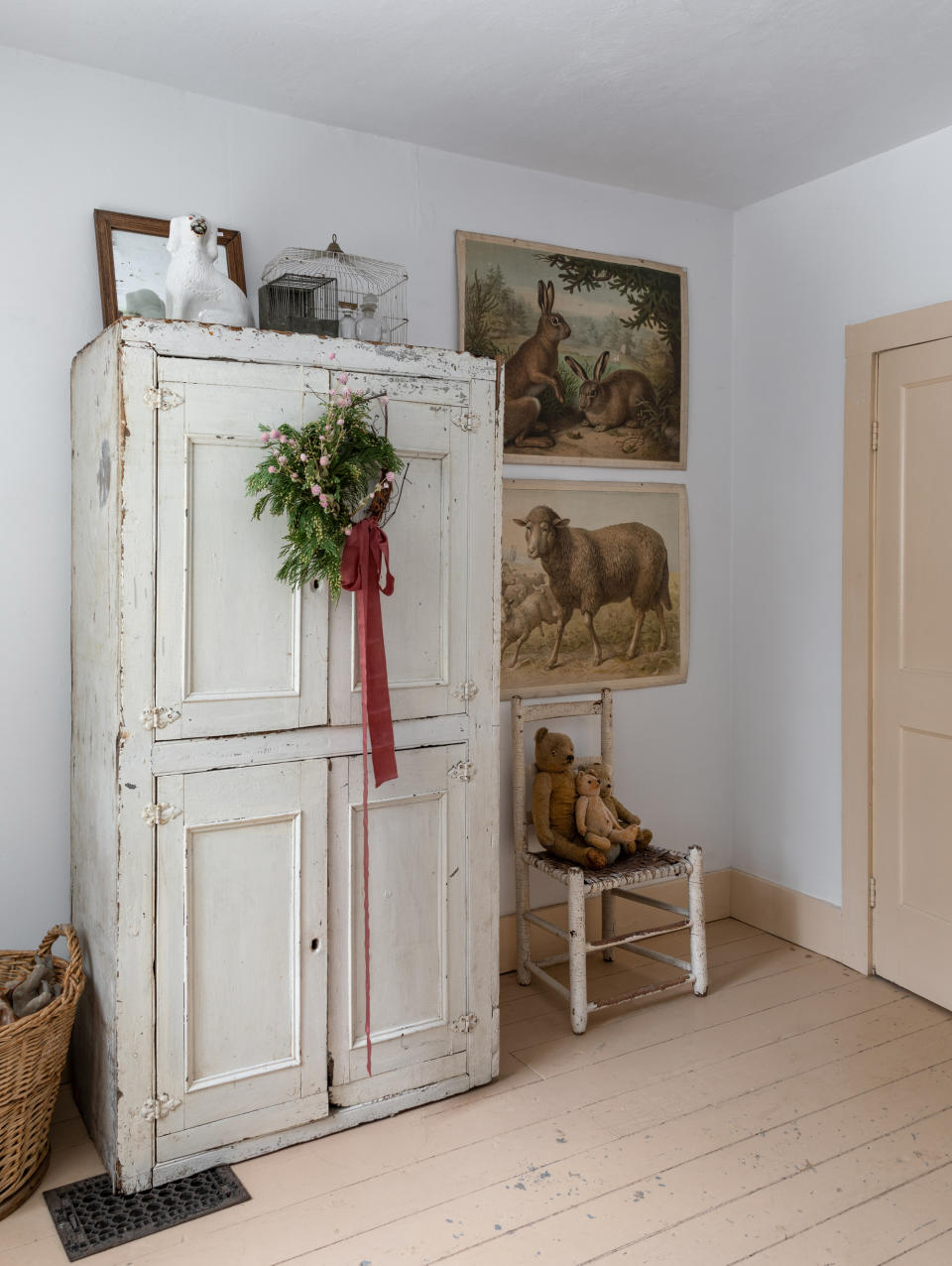 A farmhouse bedroom with a wreath on a wardrobe