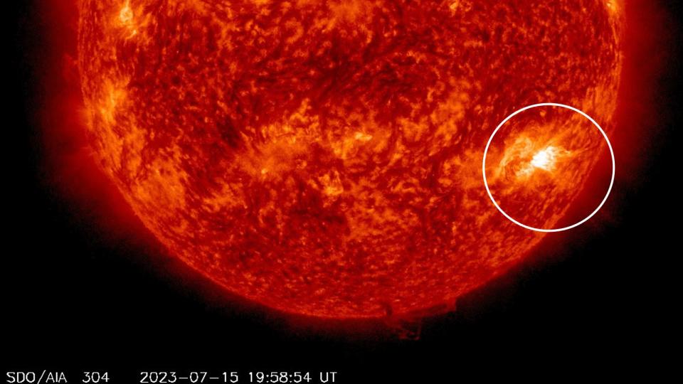 An image of the sun with a white ring surrounding the flash of a solar flare