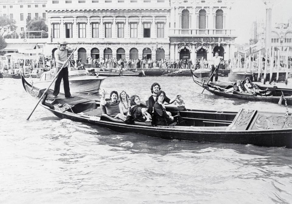 <p>Paul McCartney and his wife, Linda, seated in the back of a gondola as they and other members of McCartney's band Wings ride on a canal before their concert in St. Mark's Square in Venice in 1976.</p>