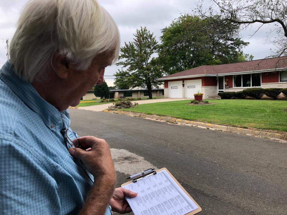 Democratic organizer Bill Chandler reviews his voter contact sheet while canvassing on Saturday, Sept. 21, 2019, in Whitewater, Wis. Chandler is executing the Democratic strategy to win back Wisconsin _ a block-by-block rebuilding of the infrastructure they let crumble ahead of the last presidential election. Many Democrats in Wisconsin, and across the Rust Belt states that President Donald Trump flipped Republican in 2016, believe their weak neighborhood network contributed to their defeat. (AP Photo/Scott Bauer)