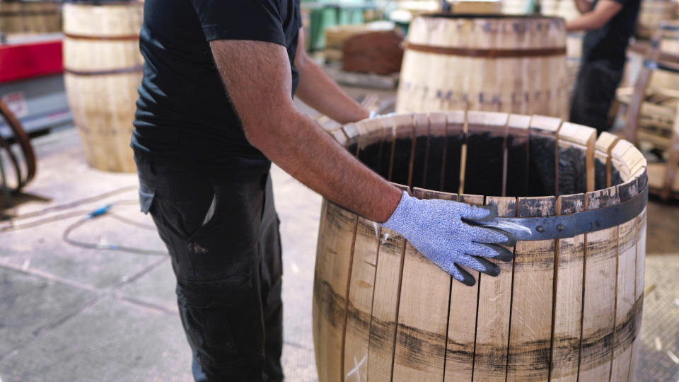 A worker at a cooperage in Jerez de la Frontera places the staves to create the barrel