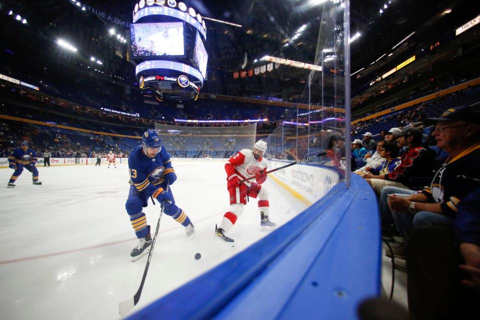 Red Wings defenseman Nick Leddy, right, passes the puck while defended by Sabres defenseman Mark Pysyk (13) during the preseason game in Buffalo, N.Y., Saturday, Oct. 9, 2021.