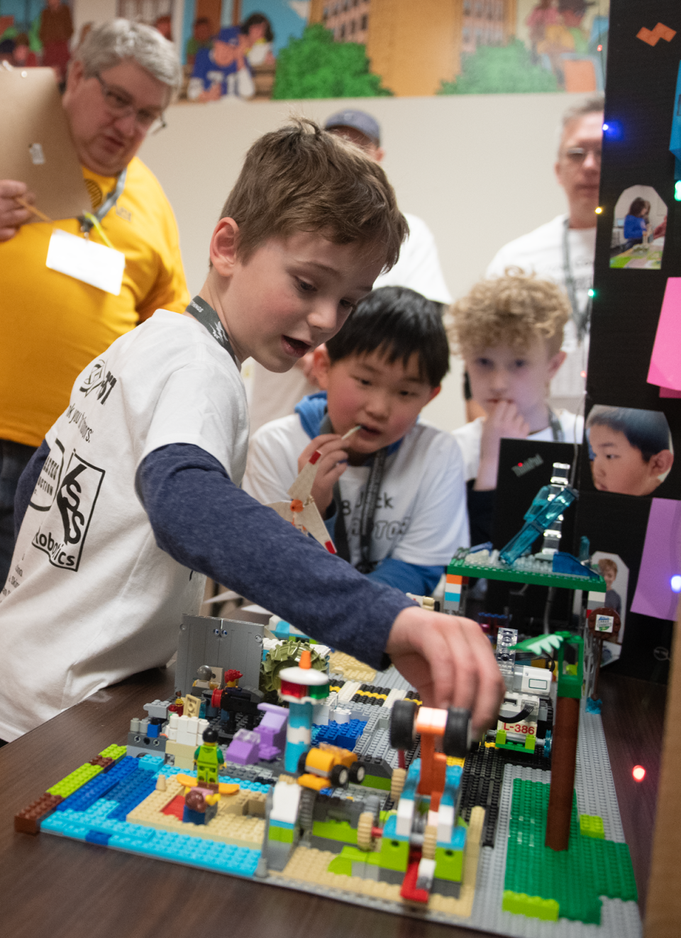 Members of the Lego Raptors team, Quin Turnidge, 7, of Kent, Jack Wang, 8, of Aurora, and Richard Martynowski, 6, of Hudson, during judging.