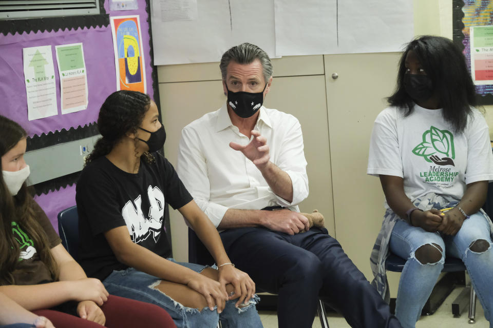 Gov. Gavin Newsom meets with students at Melrose Leadership Academy, a TK-8 school in Oakland, Calif., on Wednesday, Sept. 15, 2021, one day after defeating a Republican-led recall effort. (AP Photo/Nick Otto)