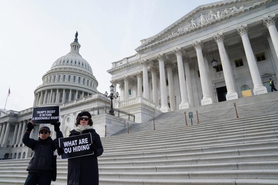 People demonstrate outside of the US Capitol on the third day of the Senate impeachment trial (REUTERS)