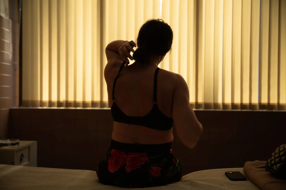 a woman sitting on a bed