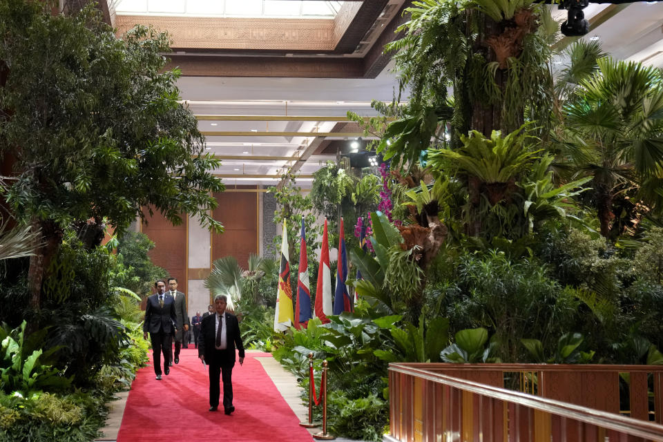 Members of the delegates walk among trees used to decorate the Jakarta Convention Center, the venue of the Association of Southeast Asian Nations (ASEAN) Summit in Jakarta, Indonesia, Tuesday, Sept. 5, 2023. Indonesian President Joko Widodo will welcome fellow Asian and world leaders with a captivating jungle scene of a two-story waterfall, wild orchids and even an orangutan perched up a tree. (AP Photo/Dita Alangkara, Pool)