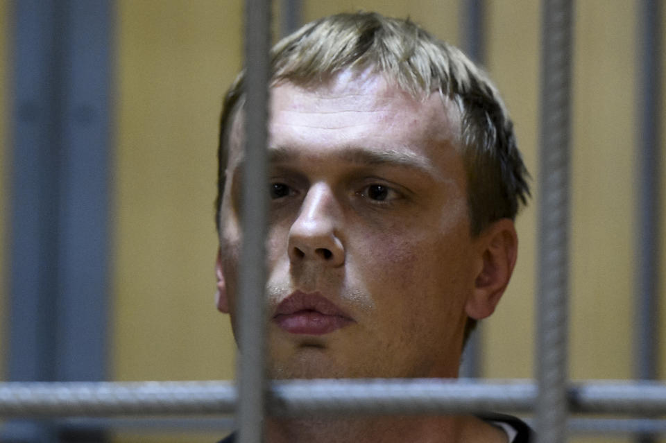Ivan Golunov, a journalist who worked for the independent website Meduza, sits in a cage in a court room in Moscow, Russia, Saturday, June 8, 2019. A prominent investigative journalist who was detained on drug-dealing charges in Russia is being taken to the hospital after complaining of feeling poorly in police custody. (AP Photo/Dmitry Serebryakov)