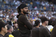 San Diego Padres' Fernando Tatis Jr. watches from the dugout during the team's baseball game against the Arizona Diamondbacks, Saturday, July 16, 2022, in San Diego. (AP Photo/Derrick Tuskan)