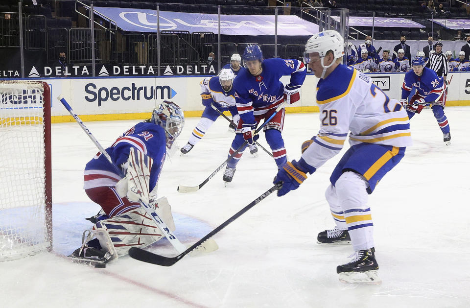New York Rangers' Igor Shesterkin (31) makes a save on Buffalo Sabres' Rasmus Dahlin (26) during the second period of an NHL hockey game Tuesday, April 27, 2021, in New York. (Bruce Bennett/Pool Photo via AP)