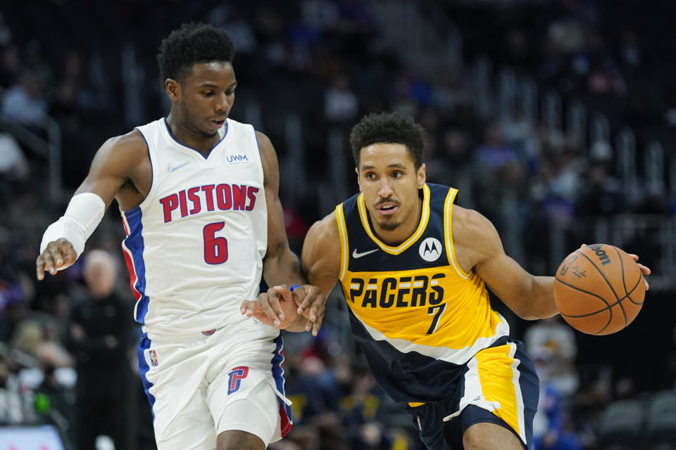 Indiana Pacers guard Malcolm Brogdon (7) drives as Detroit Pistons guard Hamidou Diallo (6) defends during the second half of an NBA basketball game, Wednesday, Nov. 17, 2021, in Detroit. (AP Photo/Carlos Osorio)