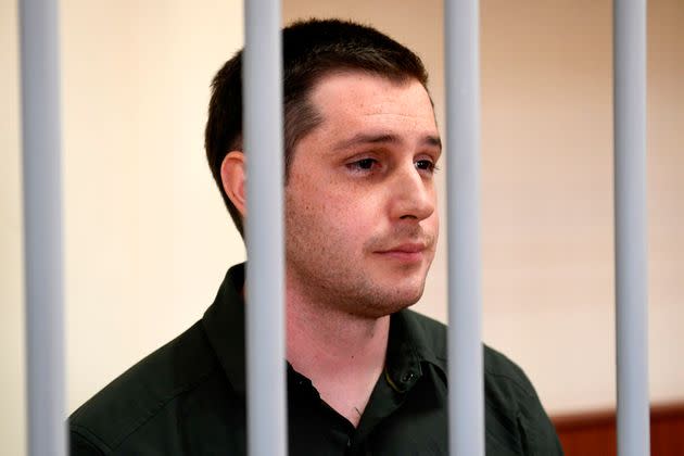 Former U.S. Marine Trevor Reed, charged with attacking police, stands inside a defendants' cage during a court hearing in Moscow on March 11, 2020. (Photo: Alexander Nemenov/AFP via Getty Images)