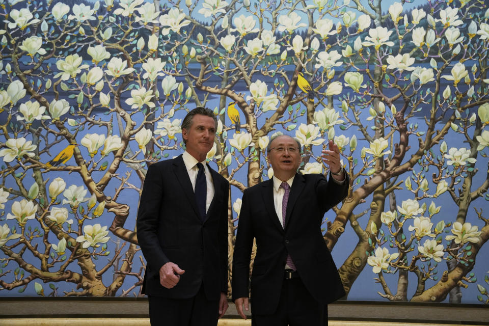 California Gov. Gavin Newsom, left., stands next to Beijing Party Secretary Yin Li during a meeting in Beijing, Thursday, Oct. 26, 2023. Newsom is on a weeklong tour of China where he is pushing for climate cooperation. His trip as governor, once considered routine, is drawing attention as it comes after years of heightening tensions between the U.S. and China. (AP Photo/Ng Han Guan)