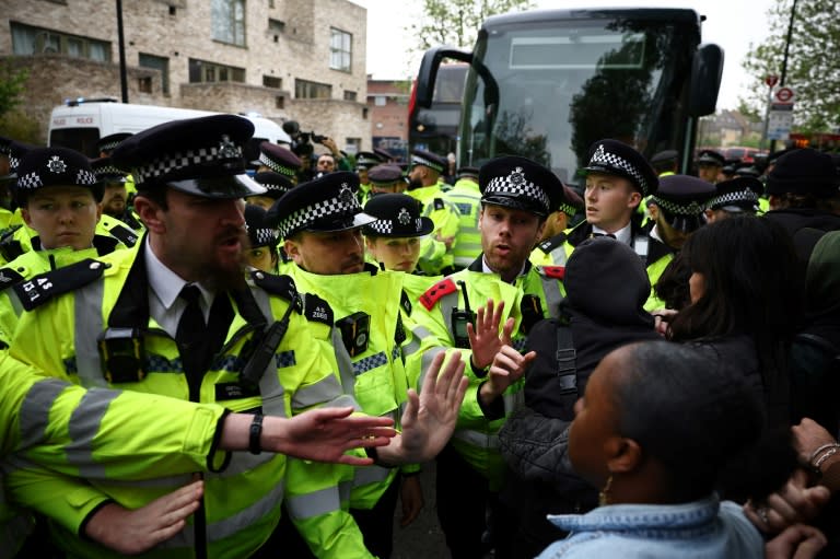 Metropolitan Police officers clash with protesters taking part in a gathering around a bus reportedly waiting to remove migrants and asylum seekers from a hotel in Peckham, south London (HENRY NICHOLLS)