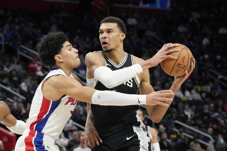 San Antonio Spurs center Victor Wembanyama, right, is defended by Detroit Pistons guard Killian Hayes during the first half of an NBA basketball game, Wednesday, Jan. 10, 2024, in Detroit. (AP Photo/Carlos Osorio)