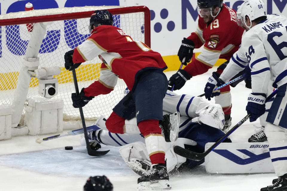 Florida Panthers center Sam Reinhart, left, scores a goal against Toronto Maple Leafs goaltender Joseph Woll, second from left, during the third period of Game 4 of an NHL hockey Stanley Cup second-round playoff series Wednesday, May 10, 2023, in Sunrise, Fla. (AP Photo/Lynne Sladky)