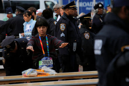 Athletics - New York City Marathon - New York, U.S. - November 5, 2017 - An entrant goes through a security check procedure conducted by police at the check-in area New York City Marathon. REUTERS/Andrew Kelly