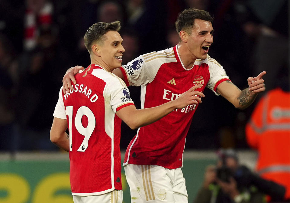 Arsenal's Leandro Trossard, left, celebrates scoring their side's first goal of the game during the English Premier League soccer match between Wolverhampton Wanderers and Arsenal at the Molineux Stadium in Wolverhampton, England, Saturday, April 20, 2024. (Mike Egerton/PA via AP)
