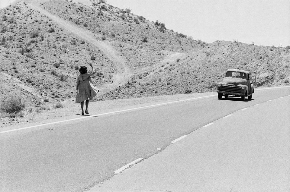 old photo of a woman hitchhiking in the 70s