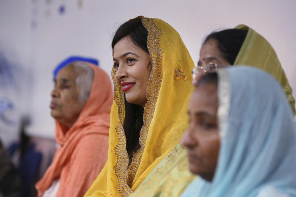 ***HOLD FOR RELIGION TEAM STORY*** From left to right, Baljinder Kaur, Renu Bhatti, Malkit Kaur and Amarjit Kaur listens to the priest during the Shri Guru Ravidass Sabha ceremony at a temple in Fresno, Calif. Sunday, May 7, 2023. Members of the Ravidassia community in California are followers of Guru Ravidass, a 14th century Indian guru of a caste formerly considered untouchable. The Ravidassia community statewide is advocating for new legislation to outlaw caste-based discrimination. (AP Photo/Gary Kazanjian)