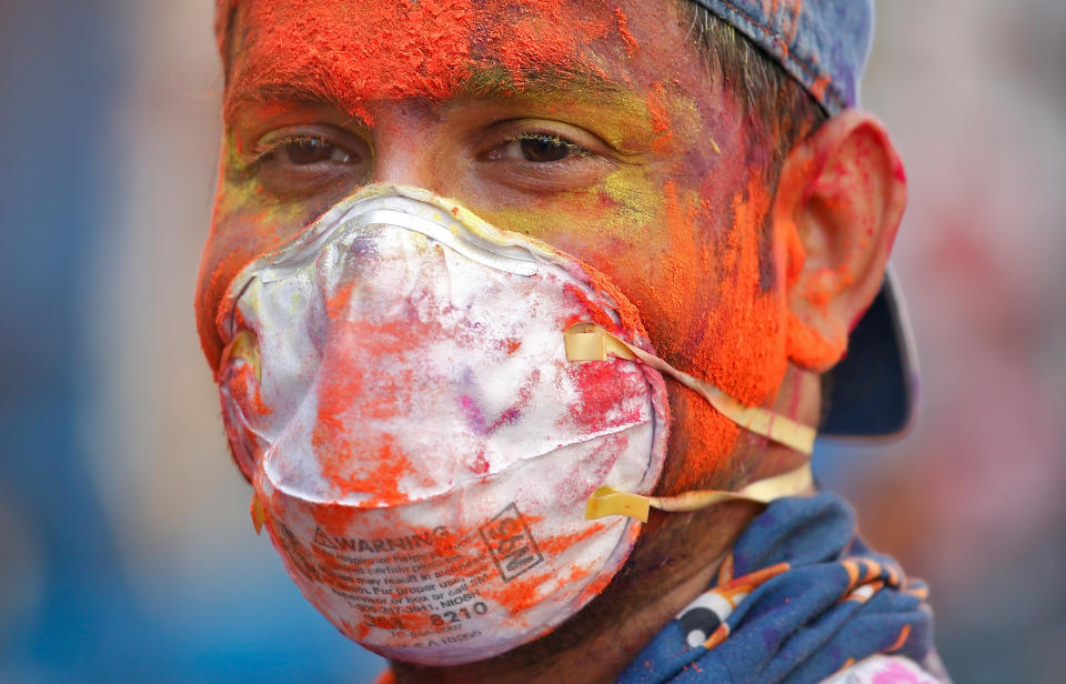 A man wearing protective mask attends Holi celebrations amid coronavirus precautions, in Chennai, India, March 10, 2020. REUTERS/P. Ravikumar