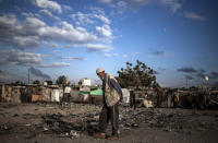 A Palestinian elderly man walks in a slum on the outskirts of Khan Younis Refugee Camp, in the southern Gaza Strip, Wednesday, Nov. 25, 2020. Israel's blockade of the Hamas-ruled Gaza Strip has cost the seaside territory as much as $16.7 billion in economic losses and caused its poverty and unemployment rates to skyrocket, a U.N. report said Wednesday, as it called on Israel to lift the 13-year closure. (AP Photo/Khalil Hamra)