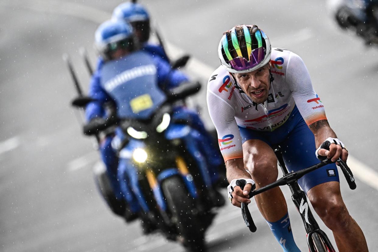 TotalEnergies' Italian rider Daniel Oss cycles in the rain, in a lone breakaway ahead of the pack of riders during the 11th stage of the 110th edition of the Tour de France cycling race, 180 km between Clermont-Ferrand and Moulins, in central France (AFP via Getty Images)