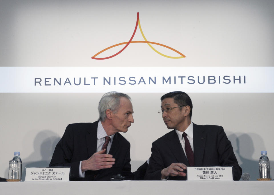 In this March 12, 2019, photo, Renault Chairman Jean-Dominique Senard, left, and Nissan CEO Hiroto Saikawa speak at the start of a joint press conference following a board meeting at the Nissan headquarters in Yokohama, near Tokyo. The chief executives of Renault, Nissan and Mitsubishi are setting up a new board to oversee the French-Japanese auto alliance. (AP Photo/Eugene Hoshiko)