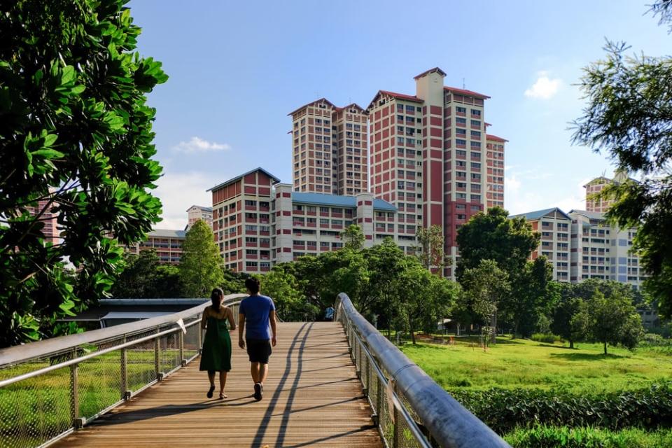 Couple walking on the bridge at Bishan-Ang Mo Kio Park