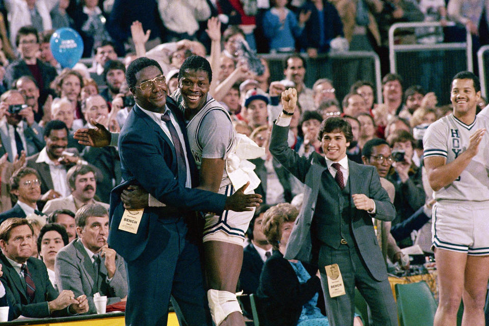 FILE - In this April 2, 1984, file photo, Georgetown head coach John Thompson, left, gives a happy pat to the most valuable player Patrick Ewing, after Georgetown defeated Houston 84-75 in Seattle. Some have likened coach Deion Sanders’ early Colorado tenure to that of the pioneering college basketball coach John Thompson, whose Georgetown Hoyas were an anomaly on a predominantly white campus but garnered the unwavering support of the hip hop and Black community. (AP Photo/File)