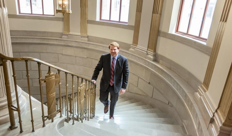 City Council member Rob Dorans ascends a staircase in City Hall.