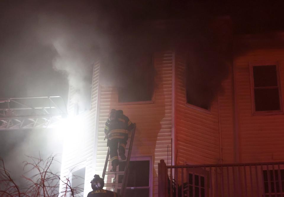 Brockton firefighters battle a three-alarm house fire at 25 Central Square on Sunday, Feb. 12, 2023.