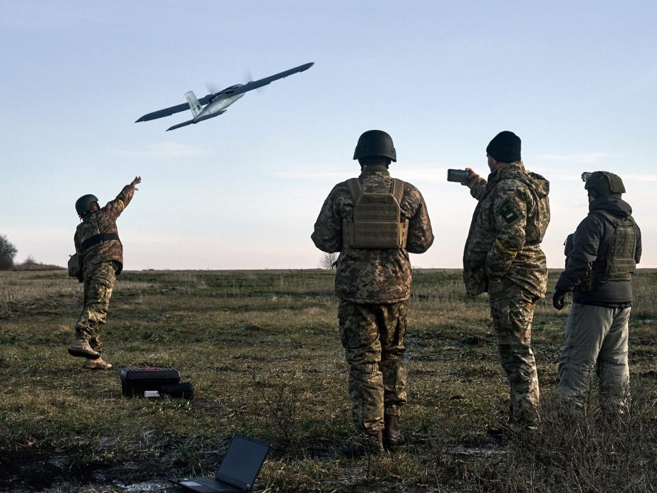 Ukrainian soldiers launching a drone