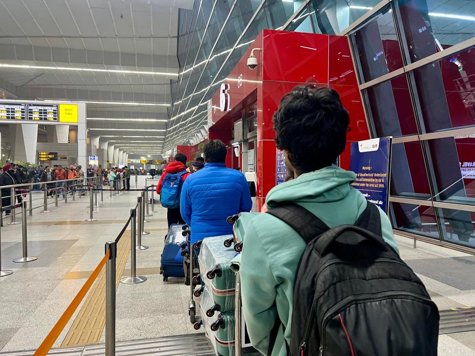 The line of people to get into the airport.