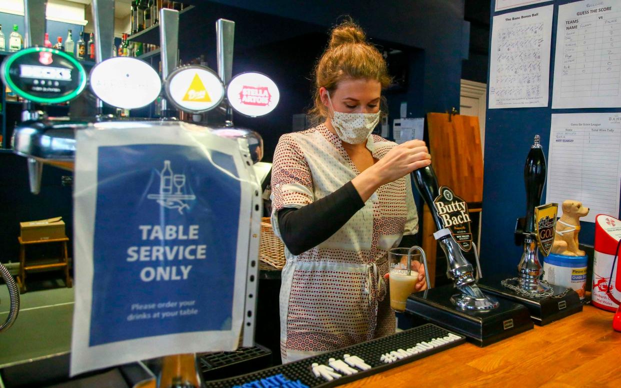 pulling a pint in a pub -  GEOFF CADDICK/AFP