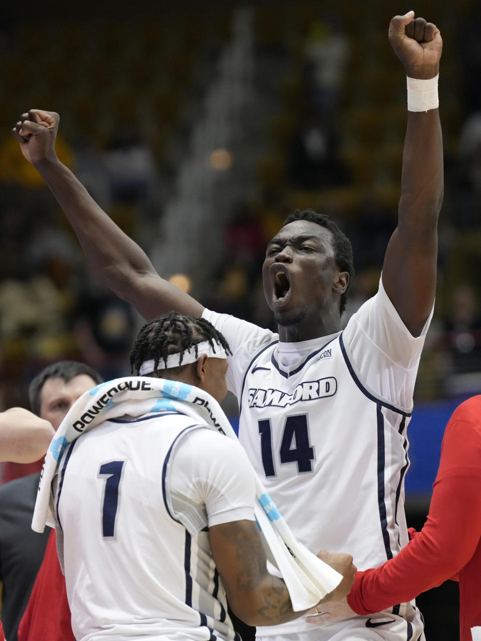 Samford forward Achor Achor (14) celebrates with seconds left in an NCAA college basketball championship game against East Tennessee State for the Southern Conference tournament, Monday, March 11, 2024, in Asheville, N.C. (AP Photo/Kathy Kmonicek)