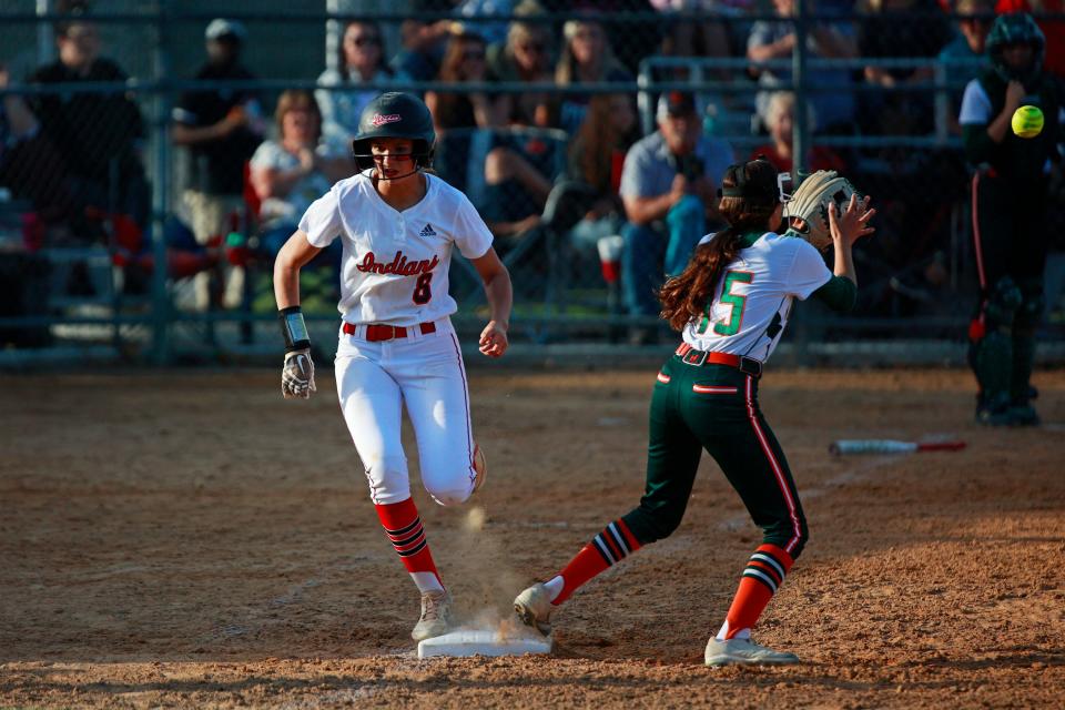 Baldwin's Kendall North (8) beats the throw to first base as Mandarin's Ava Schreiber (15) fields the throw during the second inning.