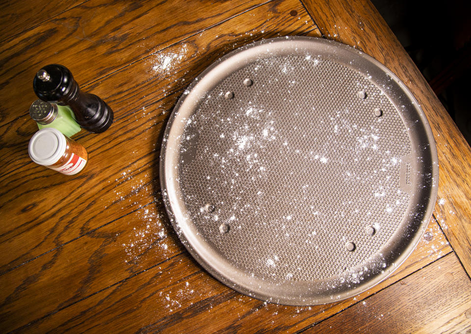 the goodcook textured pizza pan with a dusting of flour before we make pizza