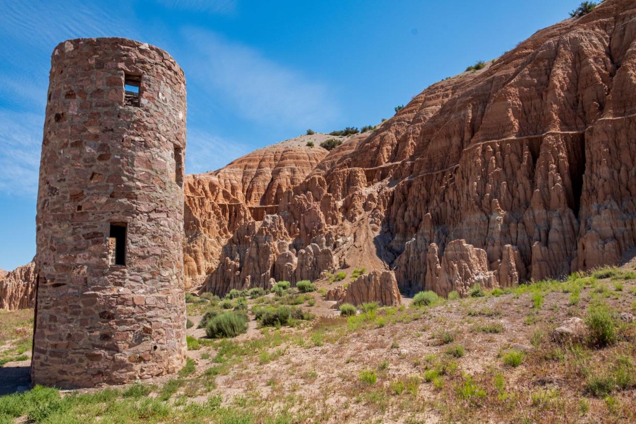 1987 Man made structure contrasts against the natural beauty of the clay hoodoos and hills at Cathedral Gorge, NV