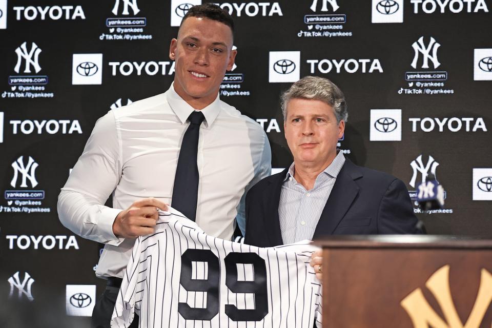 Aaron Judge #99 of the New York Yankees poses with Hal Steinbrenner during a press conference at Yankee Stadium on December 21, 2022 in Bronx, New York.