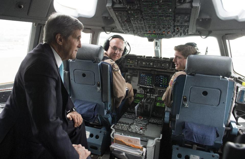 U.S. Secretary of State John Kerry, left, talks with the crew of a U.S. Air Force C-17 military airplane prior to departure from Addis Ababa, Ethiopia, enroute to Juba, South Sudan, Friday, May 2, 2014. Kerry is urging South Sudan's warring government and rebel leaders to uphold a monthslong promise to embrace a cease-fire or risk the specter of genocide through continued ethnic killings. (AP Photo/Saul Loeb, Pool)