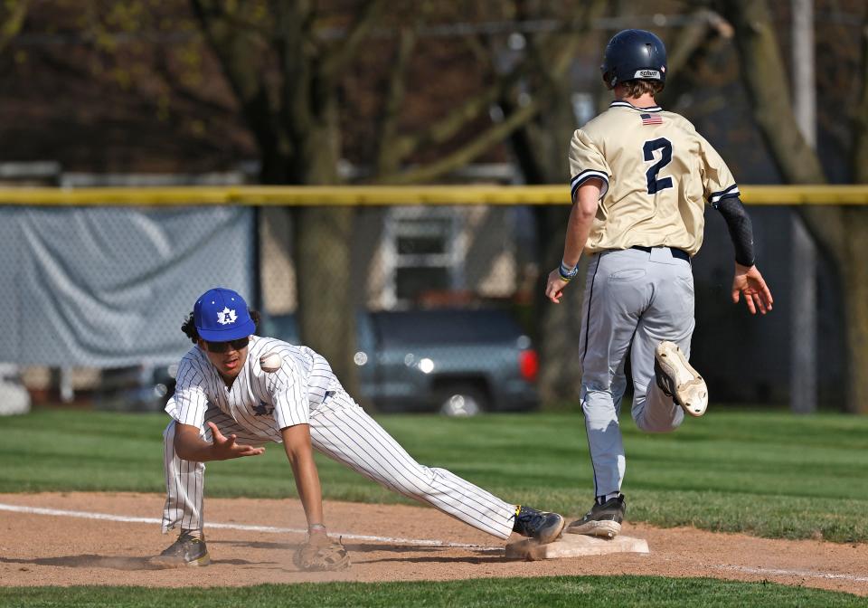 Adrian's Julius Robichaud covers first on a bunt during a game against Chelsea.