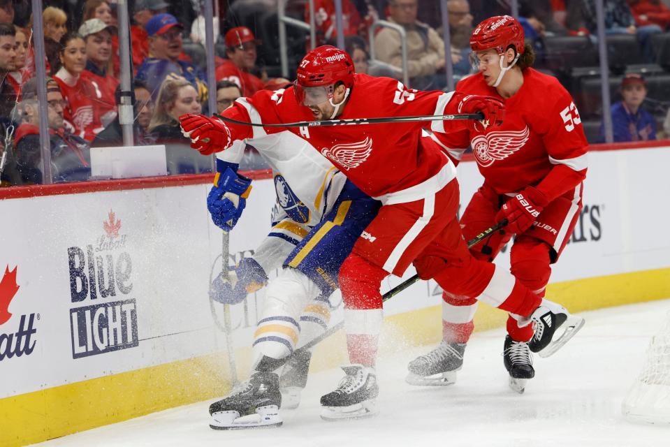 Sabres right wing Tage Thompson and Red Wings defenseman Moritz Seider, right, and left wing David Perron battle for the puck in the first period on Wednesday, Nov. 30, 2022, at Little Caesars Arena.