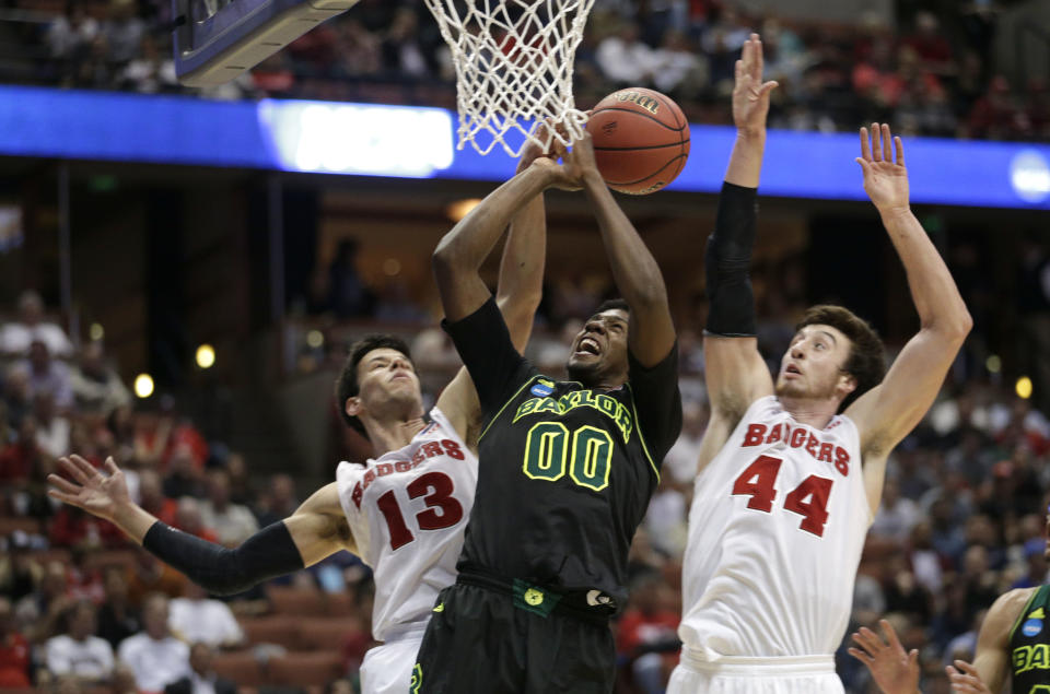 Baylor forward Royce O'Neale (00) has his shot blocked by Wisconsin forward Duje Dukan (13) as Frank Kaminsky (44) helps on defense during the second half of an NCAA men's college basketball tournament regional semifinal, Thursday, March 27, 2014, in Anaheim, Calif. (AP Photo/Jae C. Hong)