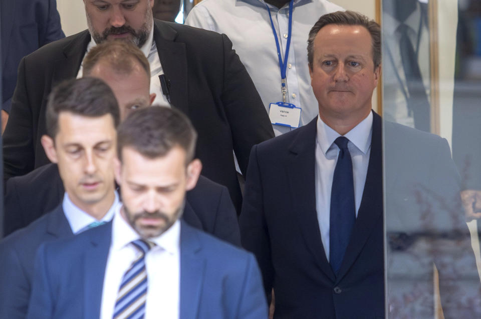 Britain's former prime minister David Cameron, right, leaves after giving evidence to the UK COVID-19 Inquiry, during its first investigation (Module 1) examining if the pandemic was properly planned for, at Dorland House in London, Monday June 19, 2023. (Jeff Moore/PA via AP)